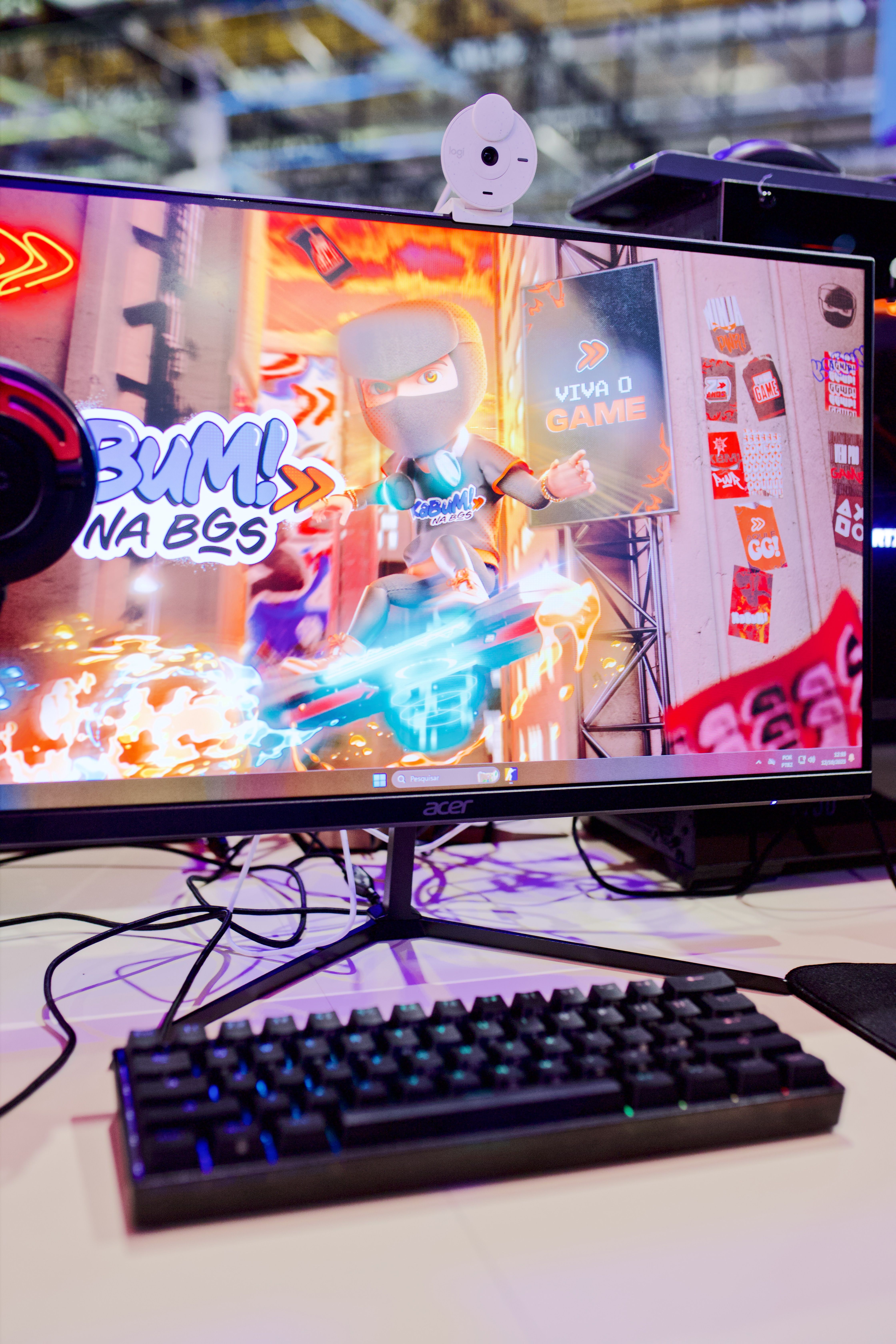 A dynamic gaming setup featuring a vibrant action scene on monitor with keyboard and gaming decor.