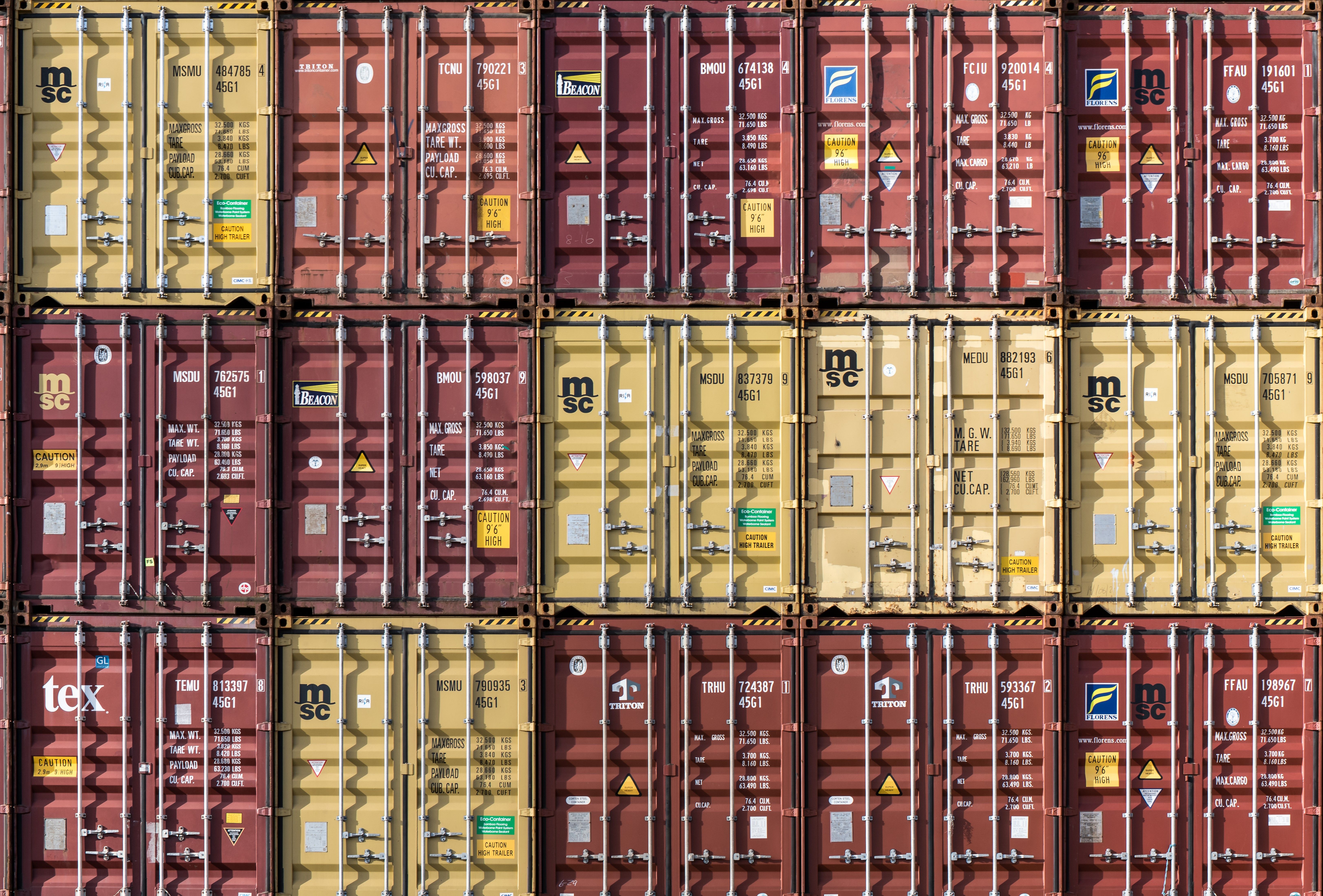 Rows of stacked shipping containers at Hamburg port. Industrial and international trade imagery.