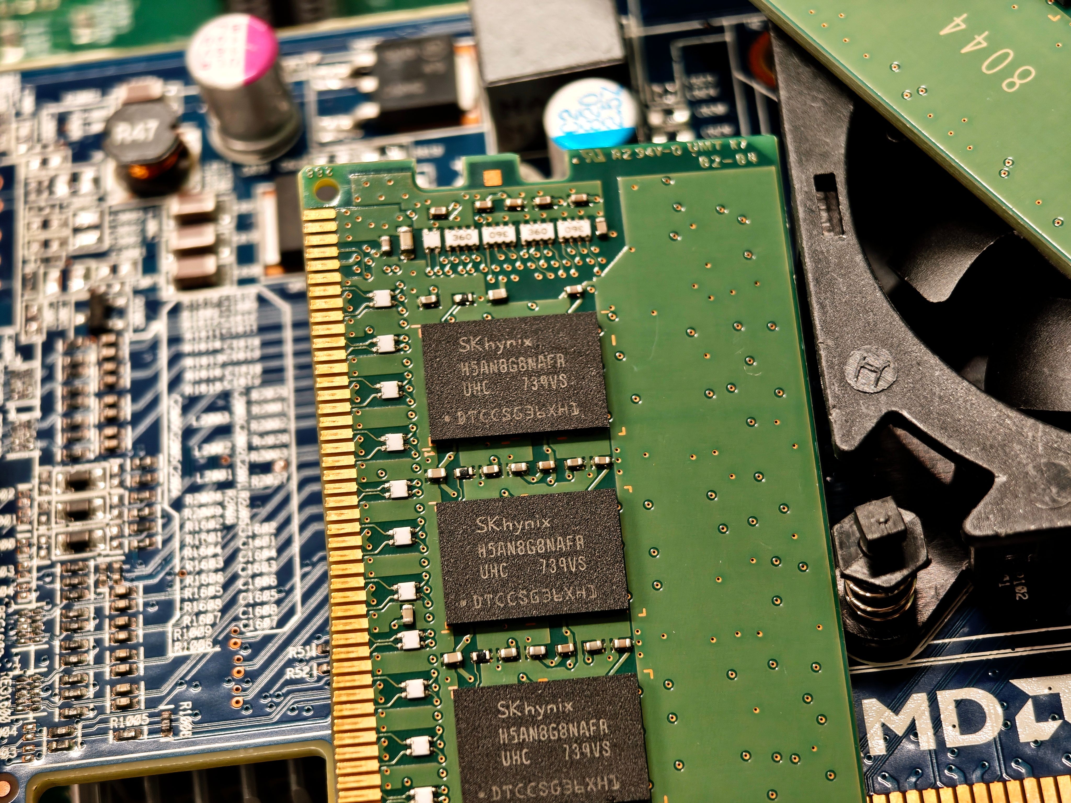 Detailed view of RAM and circuit board components in a computer setup.