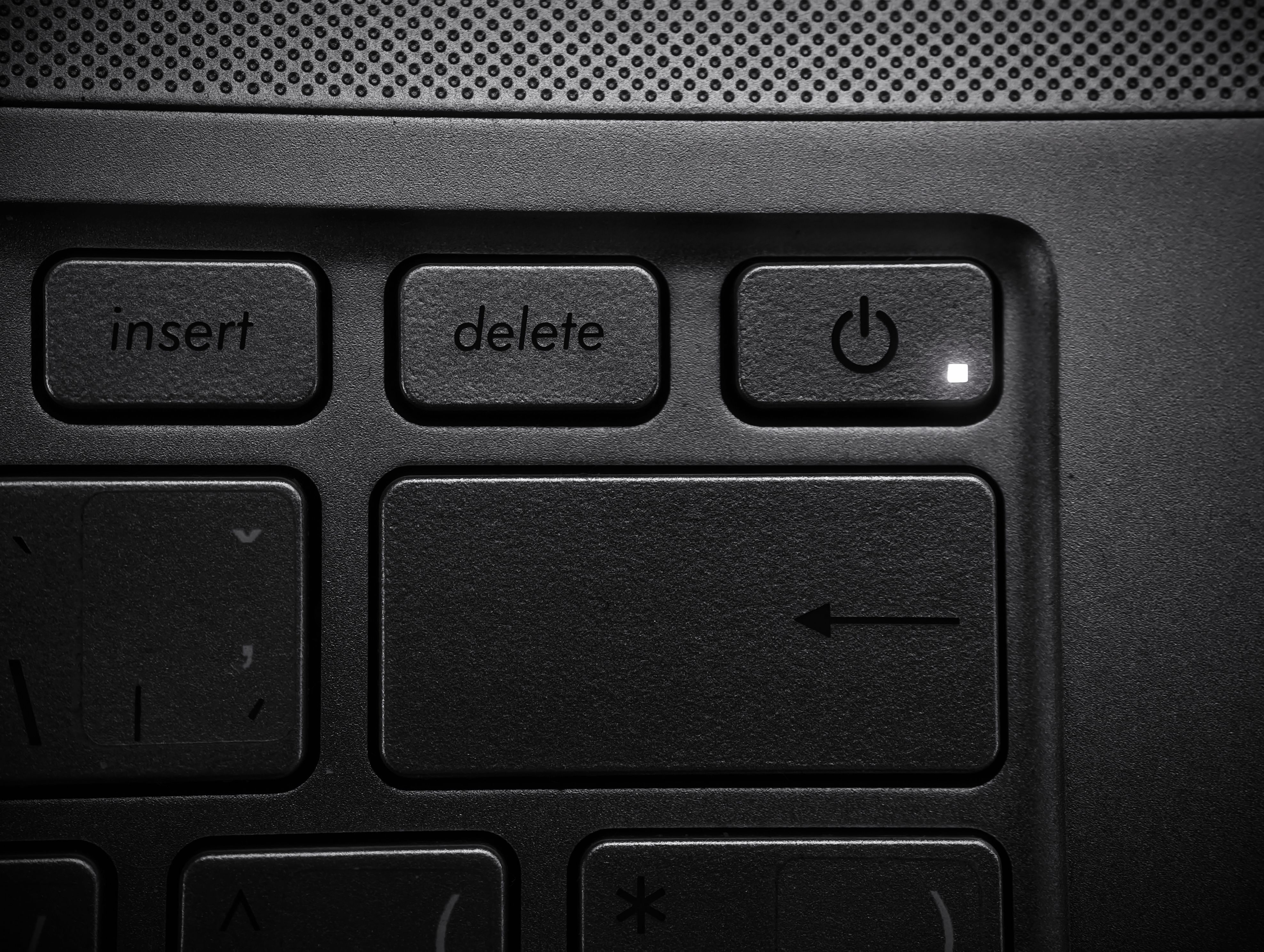 Detailed close-up of a laptop keyboard highlighting the power button and keys.