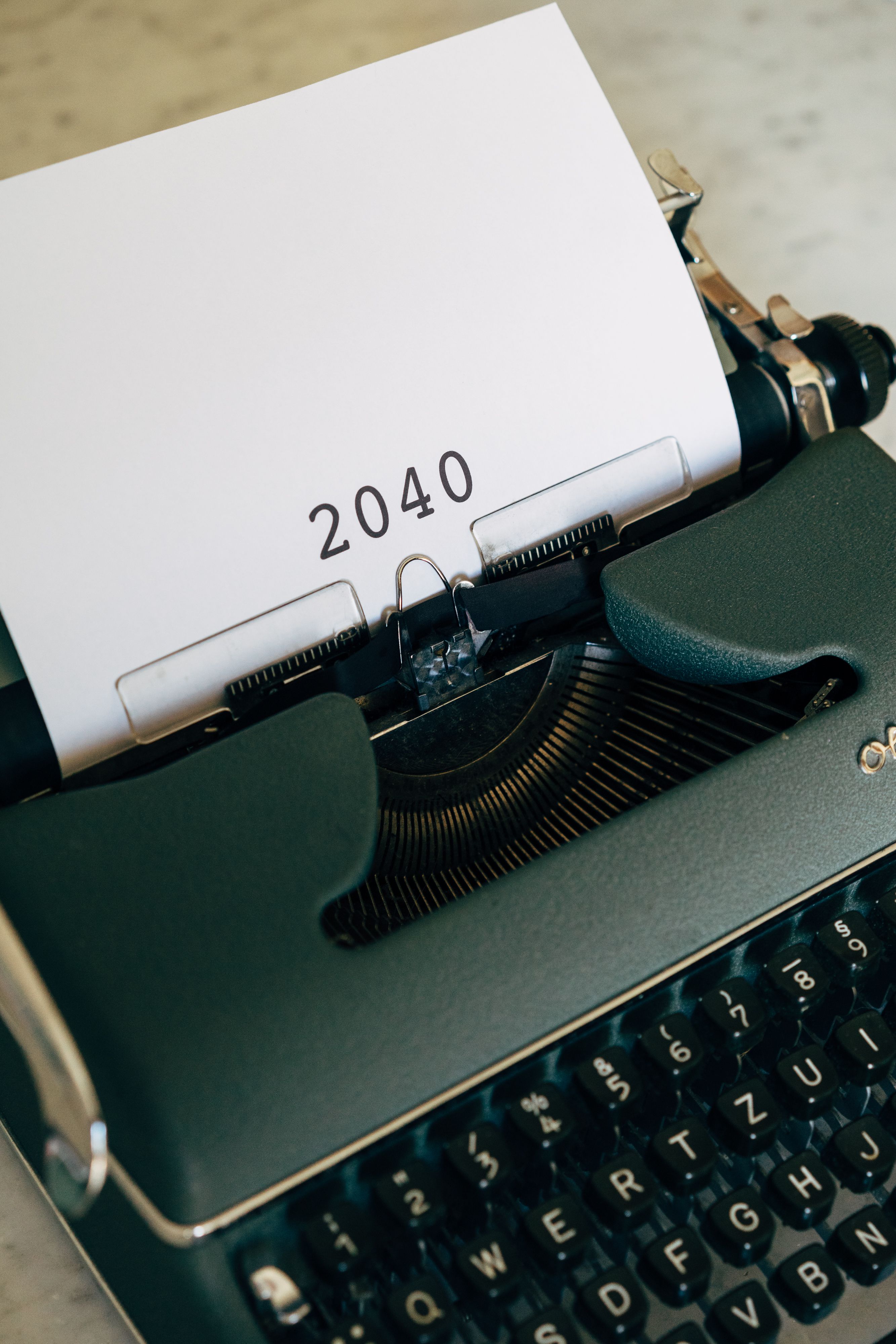 Close-up of a vintage typewriter with paper displaying the year 2040, symbolizing future concepts.