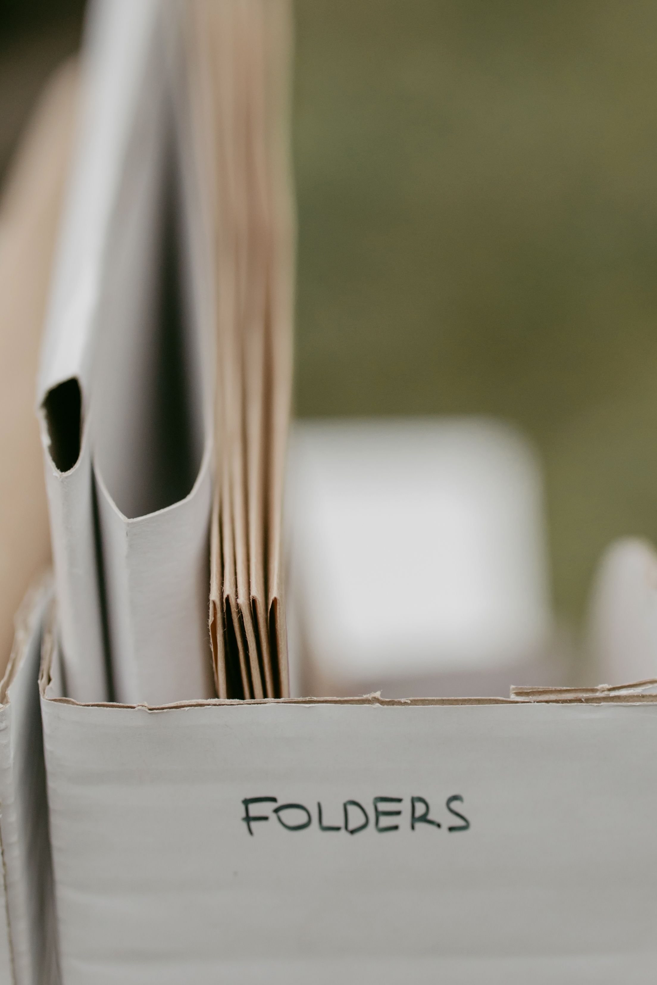 Close-up of neatly arranged folders in a box, ideal for office organization.